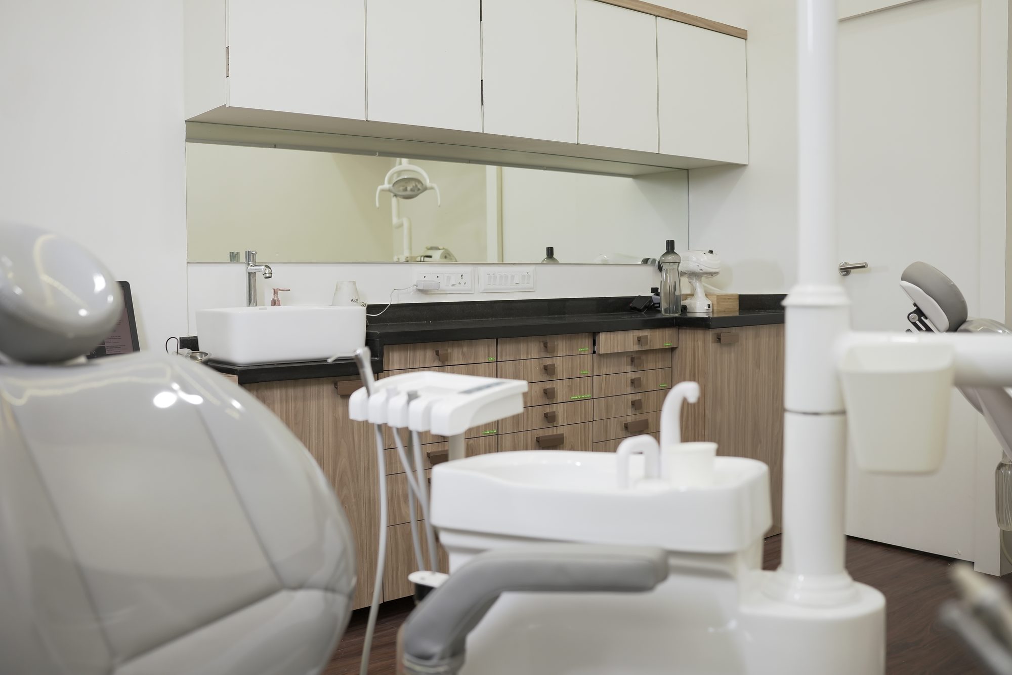 A treatment room at Suyog Dental Clinic in Mahim, with the dental chair, delivery unit and cabinetry
